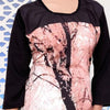 American Crepe Soft Kurti XXL, a woman wearing a black-sleeved tunic featuring a pink, white, and teal abstract tree print