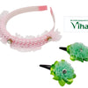 Children hair band with clips, a pink headband with white beads and frills and two green flower hair clips with black bases