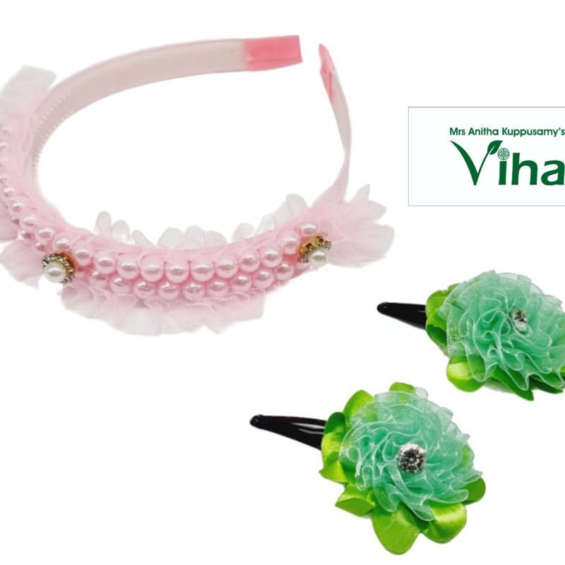 Children hair band with clips, a pink headband with white beads and frills and two green flower hair clips with black bases