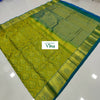 Pure Kanchipuram Silk Saree, a chartreuse textile featuring a patterned border with gold-toned motifs and a blue edge