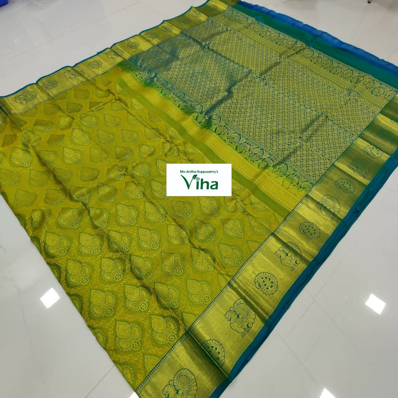 Pure Kanchipuram Silk Saree, a chartreuse textile featuring a patterned border with gold-toned motifs and a blue edge