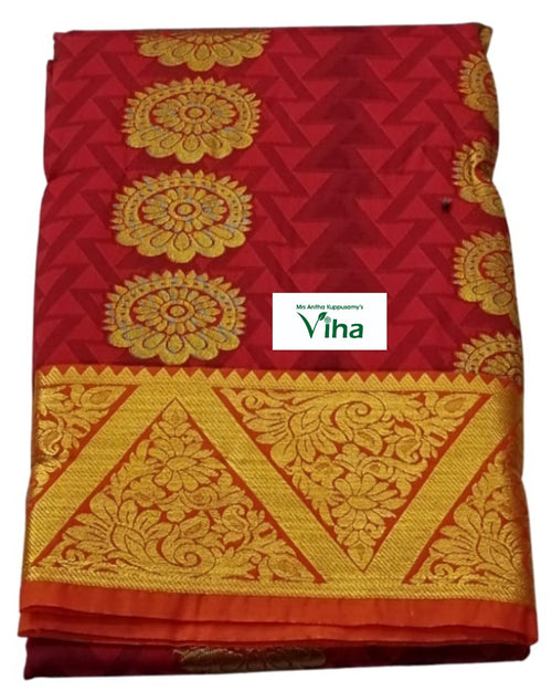 Silk Pavadai fabric folded to show a red base with a gold floral zari border