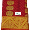 Silk Pavadai fabric folded to show a red base with a gold floral zari border