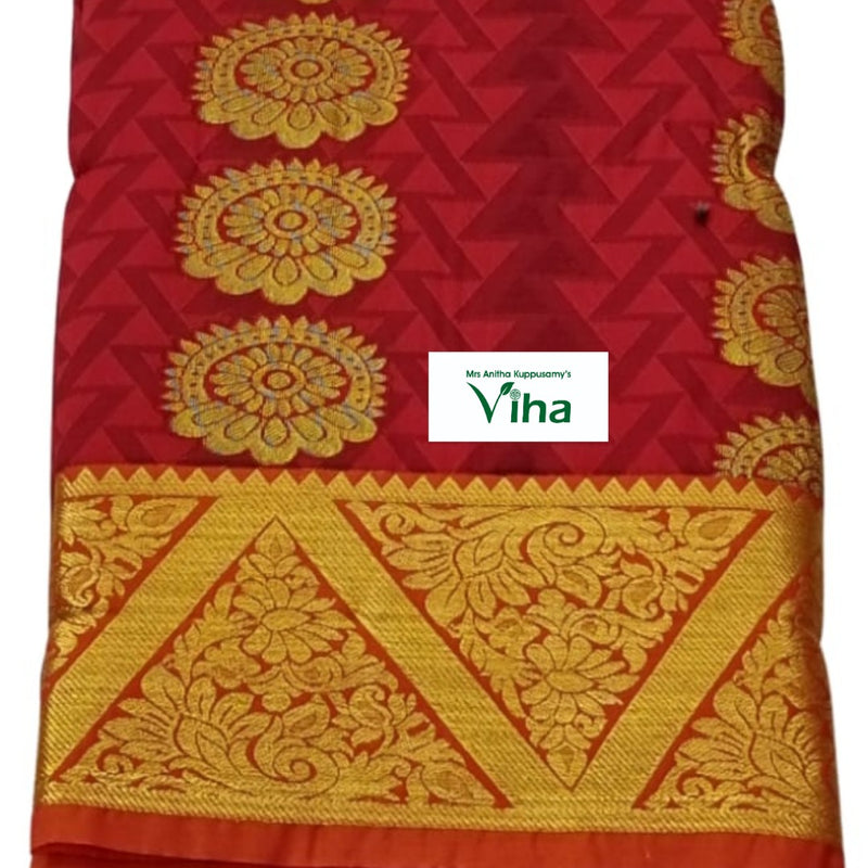 Silk Pavadai fabric folded to show a red base with a gold floral zari border
