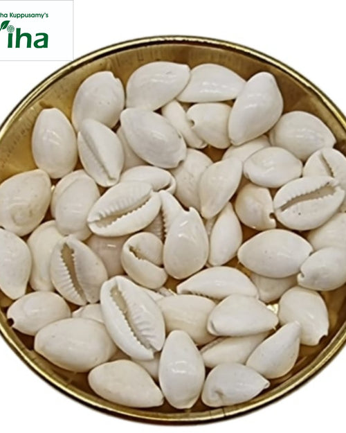 Cowrie (Sozhi), many small white cowrie shells filling a gold-toned bowl