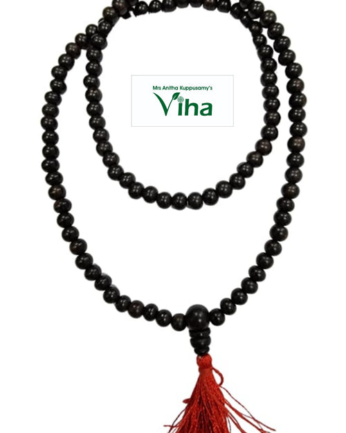 Karungali Mala 108+1 Beads, a long strand of dark brown round beads in two loops with a red tassel hanging below