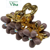 Designer Hair Clip, a shiny gold-toned claw clasp with mauve flower-shaped petals and iridescent center stones