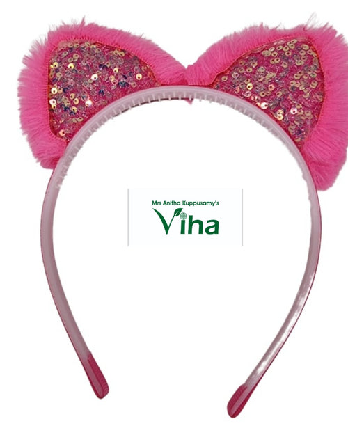 Pink hair band with two glittered ear-shaped decorations