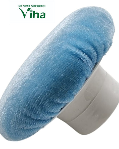 Powder Puff, a round light blue fuzzy object featuring a textured surface attached to a grey round plastic handle extending from its back