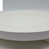 Wooden Chapati Rolling Chakla, a white round flat disk on three short rounded feet