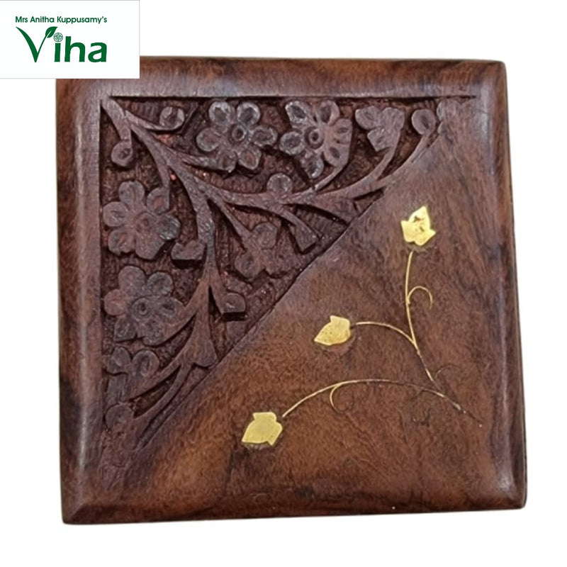Wooden Box with Brass Flower Work, a square brown wooden object with carved flowers on one half and gold-toned inlaid leaves on the other
