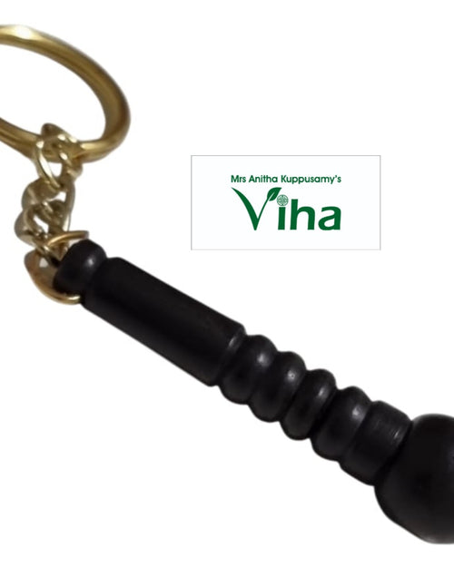Karungali Wood Hanuman Gada Design Keychain, a gold-toned ring and chain attached to a black fluted object with five ridges and a pointed tip