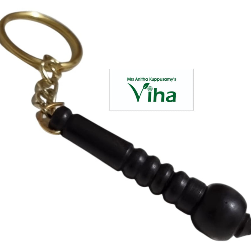 Karungali Wood Hanuman Gada Design Keychain, a gold-toned ring and chain attached to a black fluted object with five ridges and a pointed tip