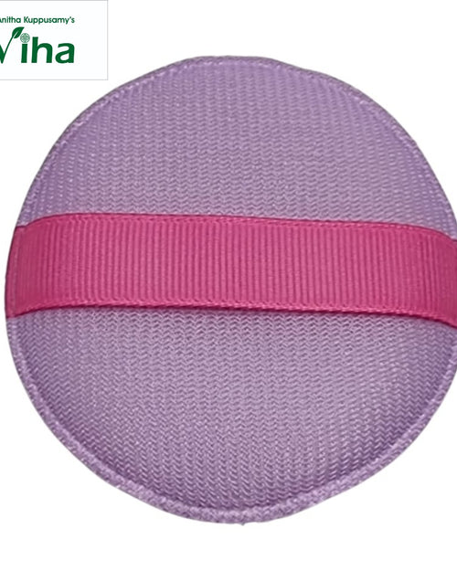 Powder Puff, a round purple textured fabric pad featuring one horizontal pink ribbed ribbon strap across its centre