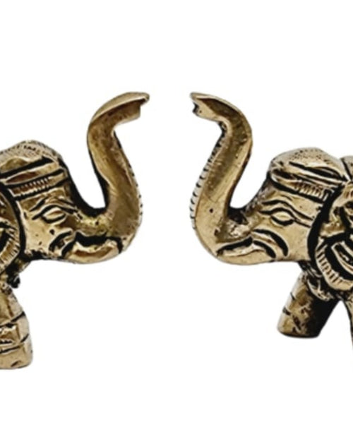 Brass elephant pair, two standing elephants with raised curled trunks and engraved bodies, facing each other