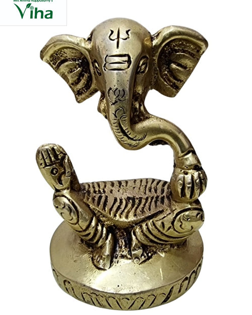 Ganesha in brass, stylised elephant head and curved trunk on a round base with a small animal at the front
