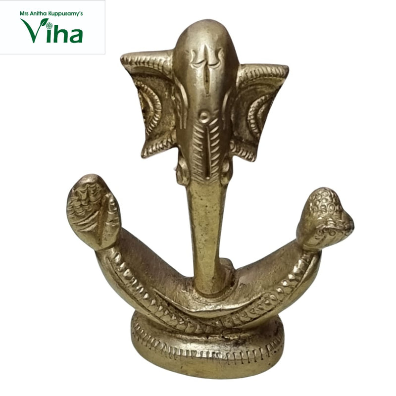 Ganesha in brass, stylised elephant head with wide flared ears and a long trunk over a crescent base