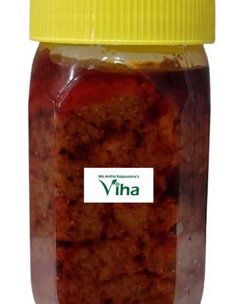 Homemade Mango Thokku, in a tall glass jar with a lid