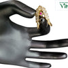 Impon Ring Adjustable, a gold-toned ornate ring with clear stones and one red stone held by a black mannequin hand