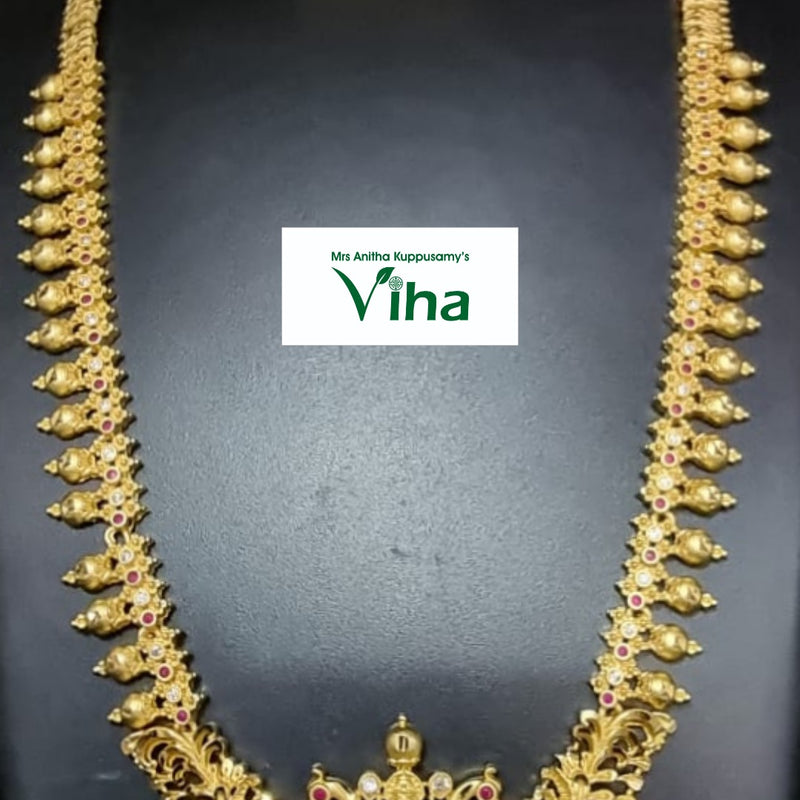 Aimpon Haram, a gold-toned necklace set with matching earrings features ornate filigree, clear stones, red stones, and dangling ball accents