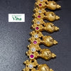 Aimpon Haram, a gold-toned necklace with flower motifs set with alternating clear stones and red circular stones, and nine bulbous hanging pendants