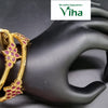 Impon Bangles, two gold-toned textured bangles with pink stone clusters worn on a black mannequin hand