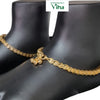 Impon Anklets (Kolusu), two gold-toned anklets with patterned links and dangling bells on black display feet