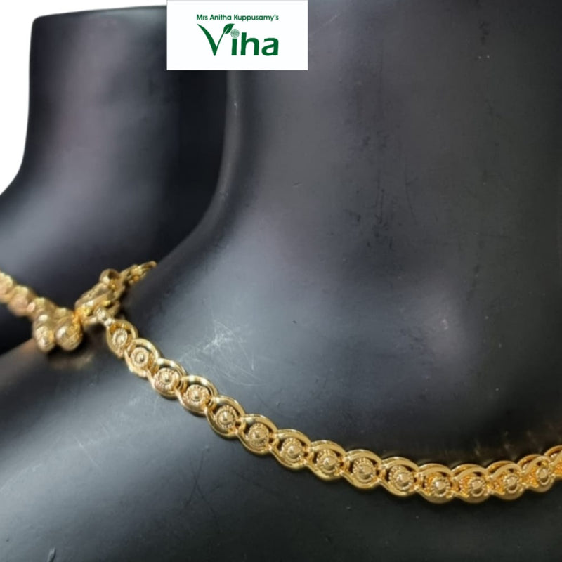 Impon Kolusu, a gold-toned circular-link anklet chain worn on a mannequin ankle