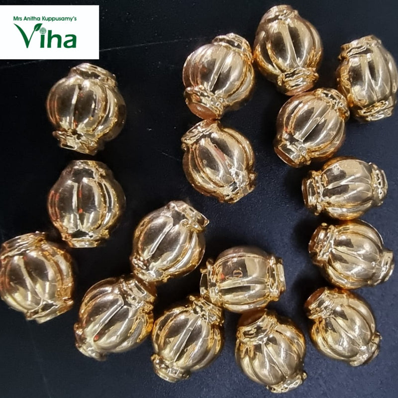 Impon Thali Kundu beads, gold-toned lantern-shaped beads piled on a dark background