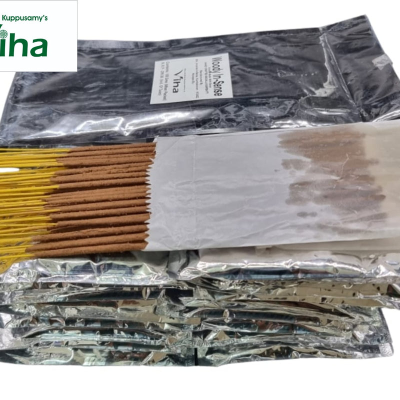 Woody Incense Sticks, a stack of eight foil pouches and a bundle of yellow-handled brown sticks