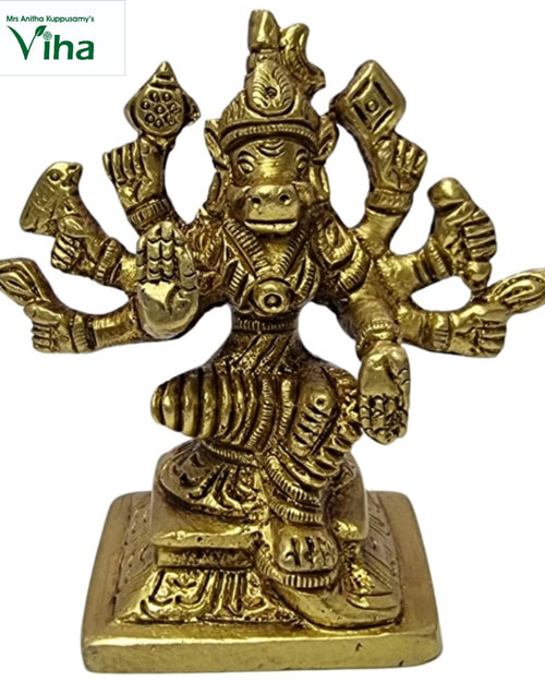 Varahi Amman in brass, boar-headed figure seated on a square base with arms fanned symmetrically to both sides