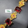 Impon Necklace Set, a gold-toned chain with alternating flower shapes featuring tiny red centers and rectangular deep-red stones in prong settings