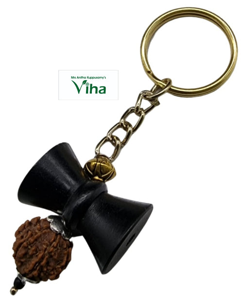 Karungali Damru Rudraksh Key Chain, a gold-toned keychain holds one black hourglass-shaped charm, one brown textured bead, and one black bead