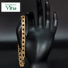Impon Bracelet (Unisex), a gold-toned flat curb link chain draped over a black mannequin hand