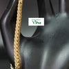 Impon Bracelet, a gold-toned flat herringbone chain draped across a glossy black mannequin hand