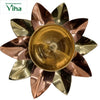 Lotus Lamp, a metallic flower-shaped bowl with ten alternating copper-toned and brass-toned petals surrounding a central circular cup with concentric rings