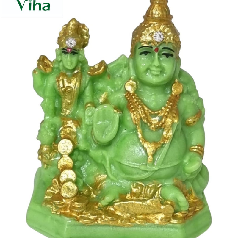 Lakshmi Kuberar, seated green figure with gold-coloured detail, a smaller standing figure behind and coins at the base