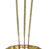 Incense Stick Holder Brass, three vertical tan incense sticks with pink bases standing in a scalloped gold-toned bowl