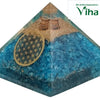 Blue Aquamarine Orgone Pyramid with EMF Protection, a clear blue pyramid containing a golden geometric circle and two metal spirals