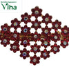 Stone Hair Clip, a gold-toned metal lattice brooch of twenty-six red flower-shaped units, each with a central clear stone