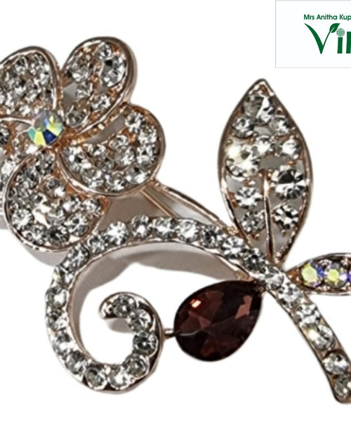 Gold-toned floral saree pin with a dark brown teardrop decoration