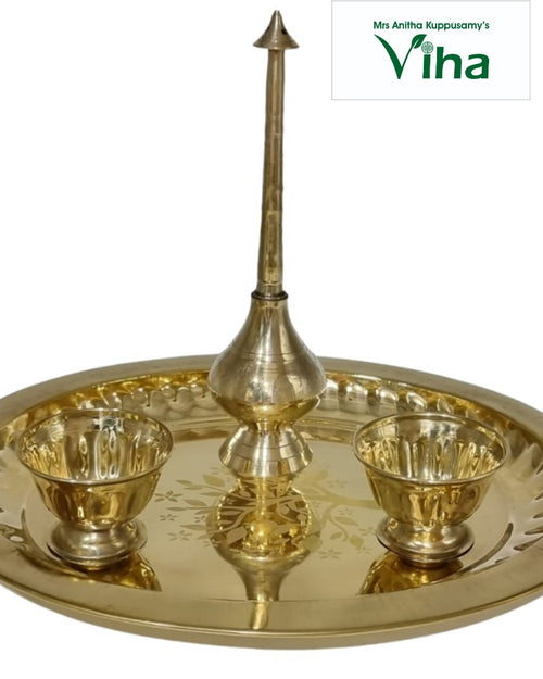 Nalungu Set, tall brass plate with etched patterns on the tray rim, tall central spire with a pointed finial