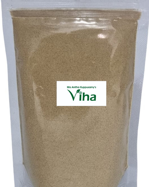 Thandrikkai Powder, a clear plastic pouch filled with brownish powder displays a rectangular white label centrally affixed on its front surface
