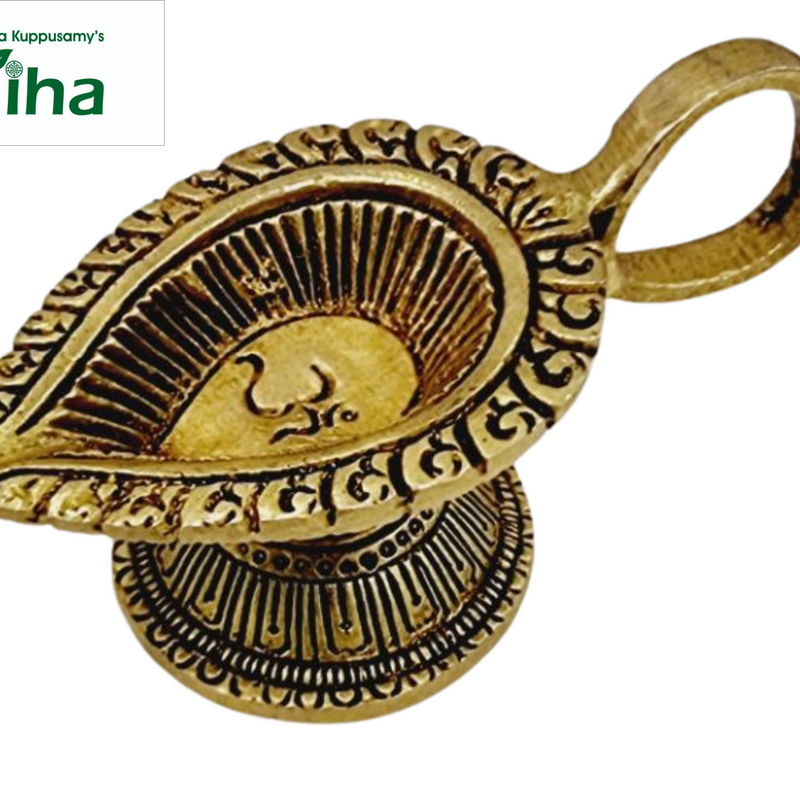 Om vilakku in antique brass, paisley oil bowl with a raised Om and a scrolled rim, loop handle behind