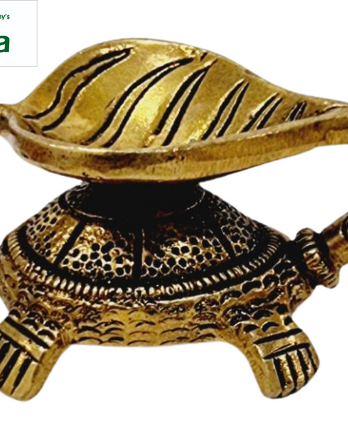 Tortoise leaf lamp in antique brass, ribbed leaf-shaped oil bowl resting on an engraved tortoise shell