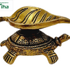 Tortoise leaf lamp in antique brass, ribbed leaf-shaped oil bowl resting on an engraved tortoise shell