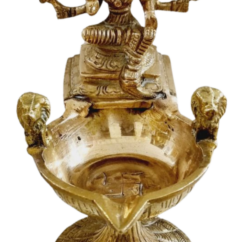 Varahi Amman vilakku, seated multi-armed figure above a deep brass oil bowl flanked by lion heads