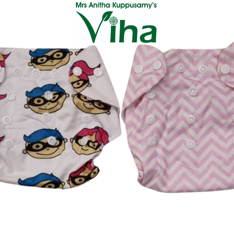 Cloth Diaper for Babies in a white superhero-print piece and a pink chevron-print piece, both with snap closures