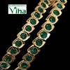 Impon Bangles, two gold-toned bangles with a shiny metallic finish, each set with round green stones in rectangular linked sections