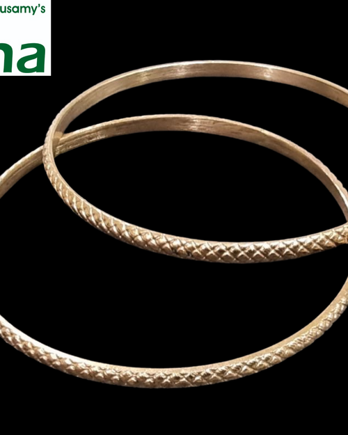 Impon Baby Bangles, two gold-toned metal bangles with textured crosshatch patterns and smooth inner bands against a black background